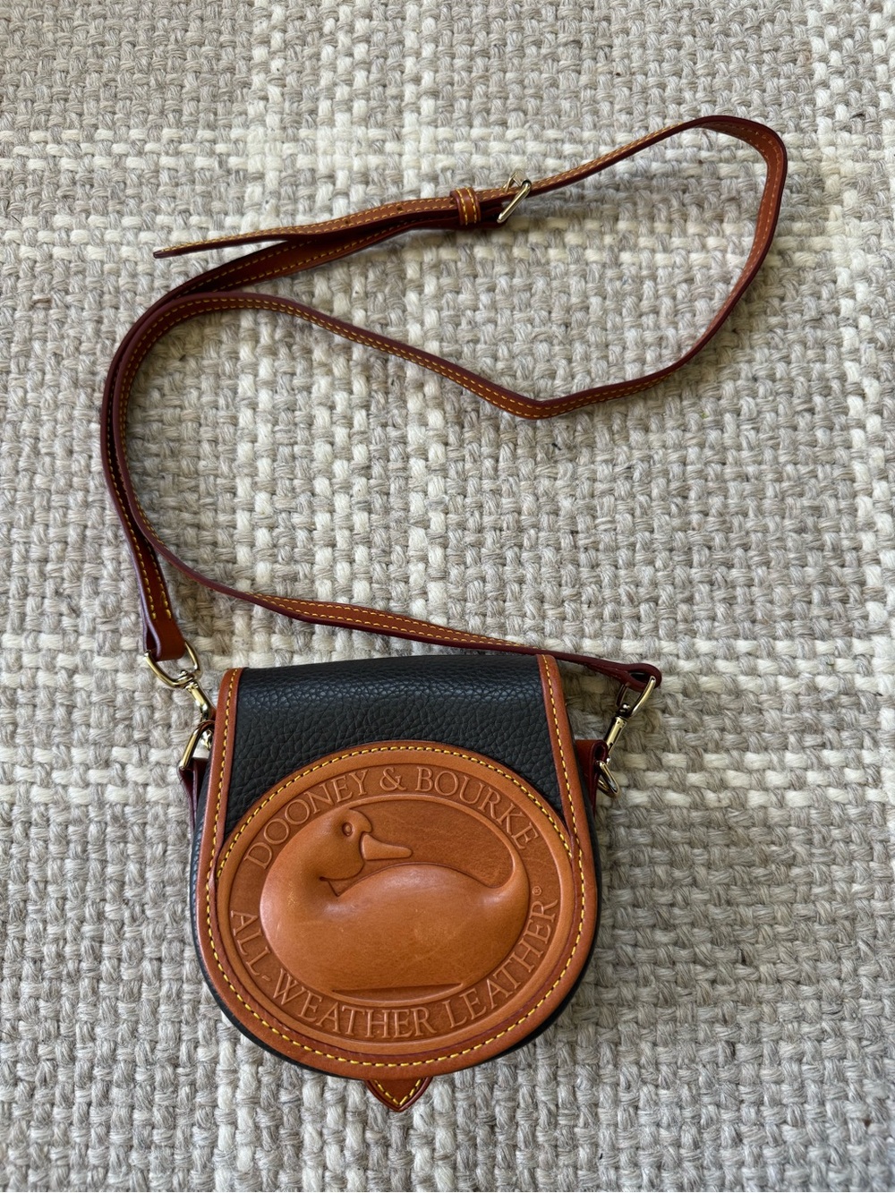 Dooney & Bourke All Weather duck small pebbles leather cross body bag